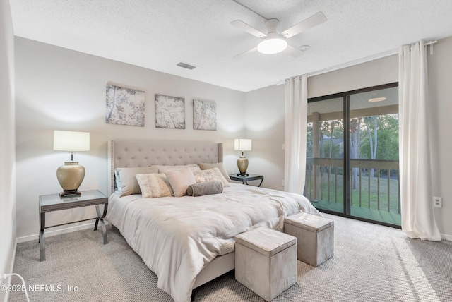 7908 Los Robles Ct Unit 7908, Jacksonville, FL 32256 - bedroom with a textured ceiling, visible vents, baseboards, light carpet, and access to outside