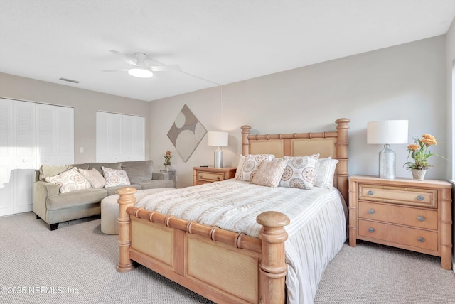 7908 Los Robles Ct Unit 7908, Jacksonville, FL 32256 - bedroom with a ceiling fan, visible vents, multiple closets, and light carpet