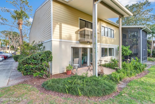 7908 Los Robles Ct Unit 7908, Jacksonville, FL 32256 - back of house with a balcony, a sunroom, and a patio area