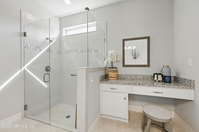 full bath featuring baseboards and a shower stall