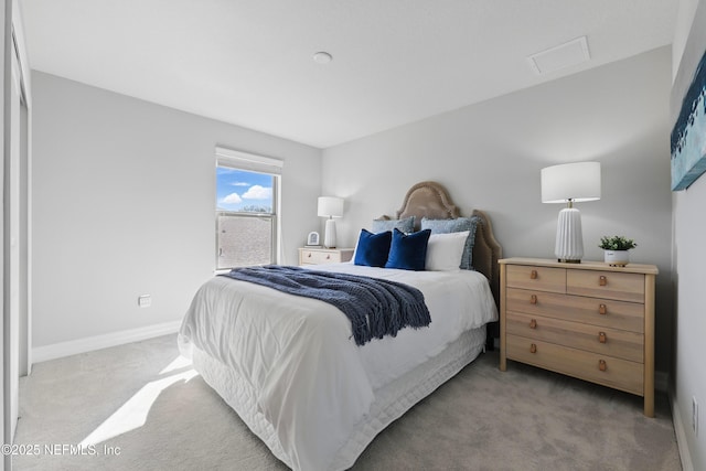 carpeted bedroom featuring baseboards and attic access