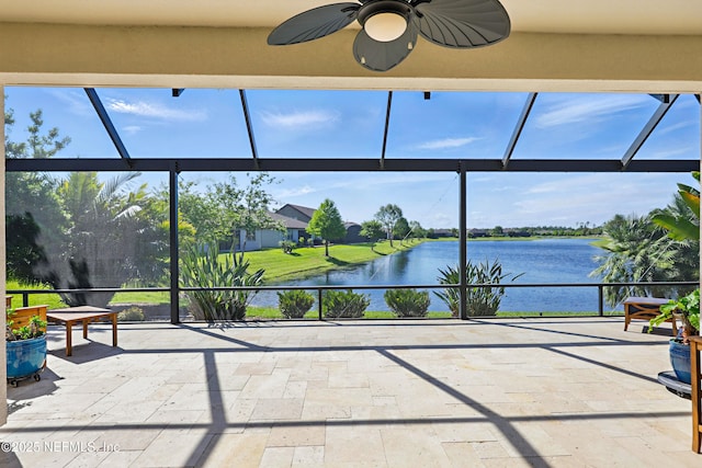 sunroom with a water view and ceiling fan