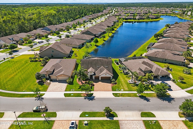 drone / aerial view with a water view and a residential view