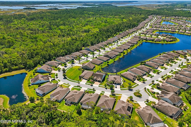 bird's eye view with a residential view, a view of trees, and a water view