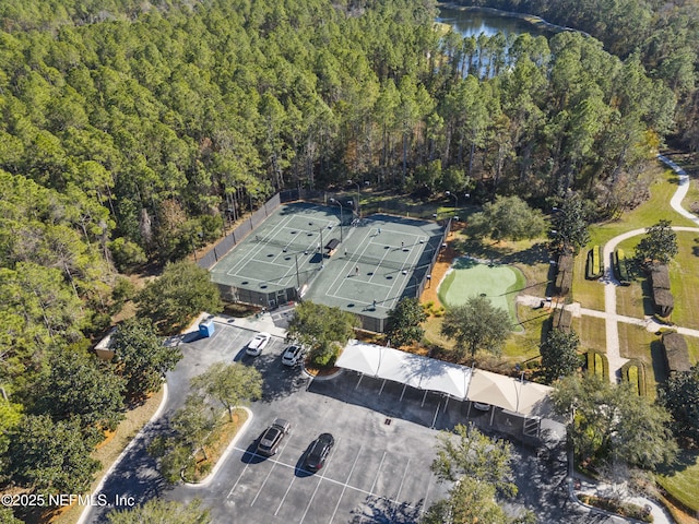 aerial view with a forest view and a water view