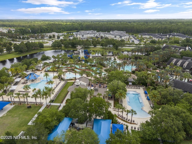 birds eye view of property with a water view and a wooded view