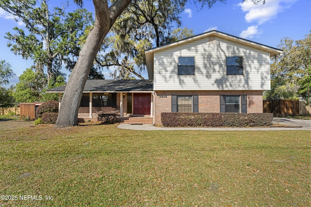 2848 Cedarcrest Dr, Orange Park, FL 32073 - split level home featuring brick siding, a front lawn, and fence