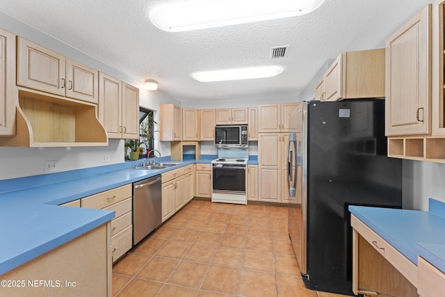 2848 Cedarcrest Dr, Orange Park, FL 32073 - kitchen featuring light brown cabinets, stainless steel appliances, and a sink