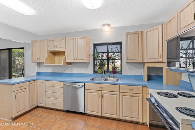 2848 Cedarcrest Dr, Orange Park, FL 32073 - kitchen featuring a sink, a textured ceiling, light brown cabinetry, light tile patterned floors, and appliances with stainless steel finishes