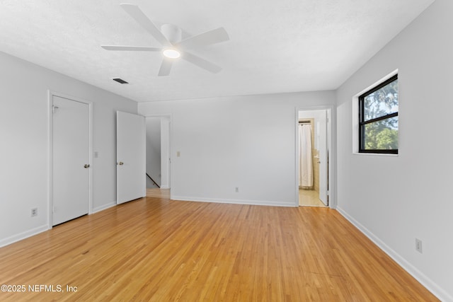 2848 Cedarcrest Dr, Orange Park, FL 32073 - unfurnished bedroom featuring light wood finished floors, ensuite bathroom, baseboards, visible vents, and a ceiling fan