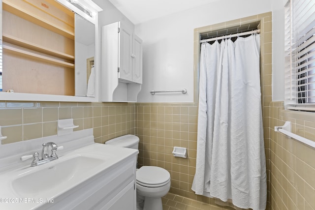2848 Cedarcrest Dr, Orange Park, FL 32073 - bathroom featuring a wainscoted wall, toilet, tile walls, curtained shower, and vanity