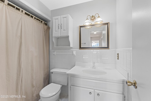 2848 Cedarcrest Dr, Orange Park, FL 32073 - bathroom featuring tile walls, wainscoting, vanity, and toilet