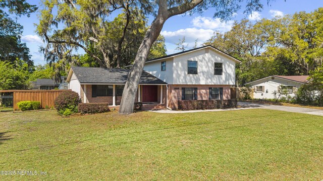 2848 Cedarcrest Dr, Orange Park, FL 32073 - split level home featuring concrete driveway, a front lawn, brick siding, and fence