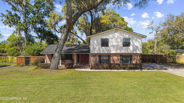2848 Cedarcrest Dr, Orange Park, FL 32073 - split level home with brick siding, concrete driveway, a front yard, and fence