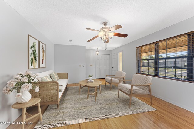 2848 Cedarcrest Dr, Orange Park, FL 32073 - living area with baseboards, wood finished floors, a textured ceiling, and ceiling fan
