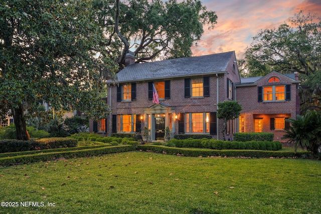 2127 River Rd, Jacksonville, FL 32207 - colonial inspired home with brick siding, a front lawn, and a chimney