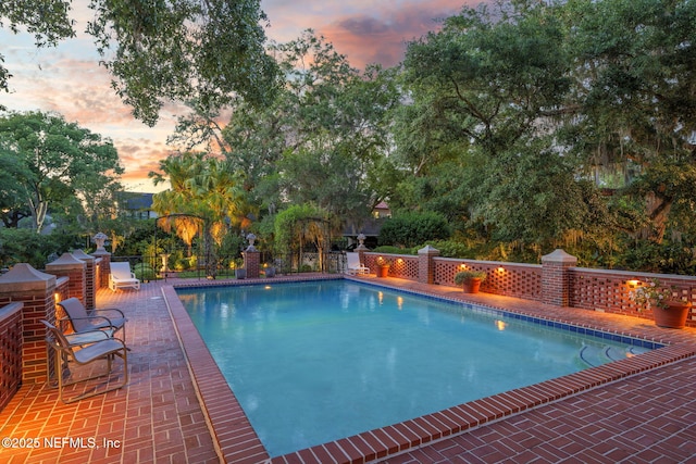 2127 River Rd, Jacksonville, FL 32207 - pool at dusk with a patio