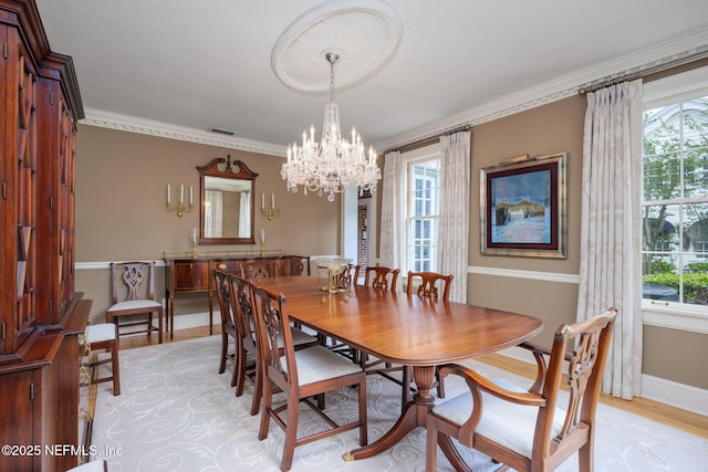 2127 River Rd, Jacksonville, FL 32207 - dining room featuring a chandelier, light wood-style floors, and ornamental molding