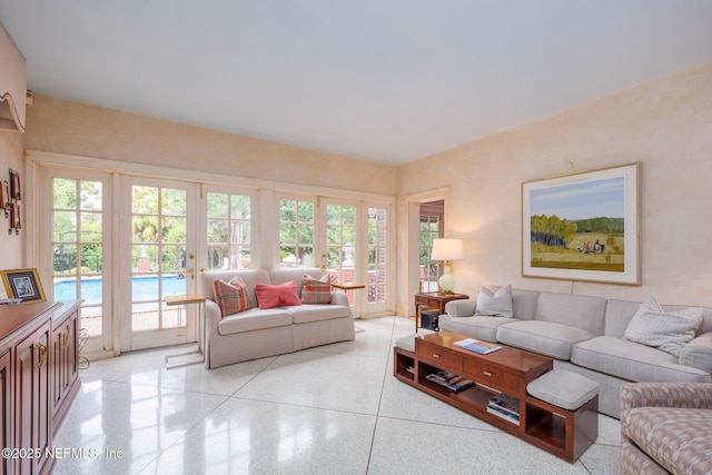 2127 River Rd, Jacksonville, FL 32207 - living area featuring french doors, dark speckled floor, and plenty of natural light