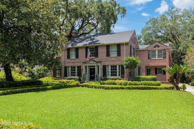 2127 River Rd, Jacksonville, FL 32207 - view of front facade featuring a front lawn, brick siding, and a chimney