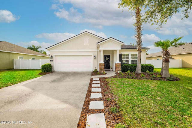 view of front facade with fence, driveway, a front yard, and a garage
