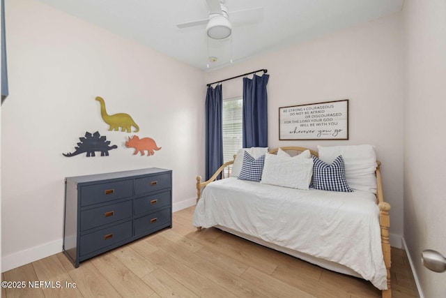 bedroom with light wood-type flooring, baseboards, and ceiling fan
