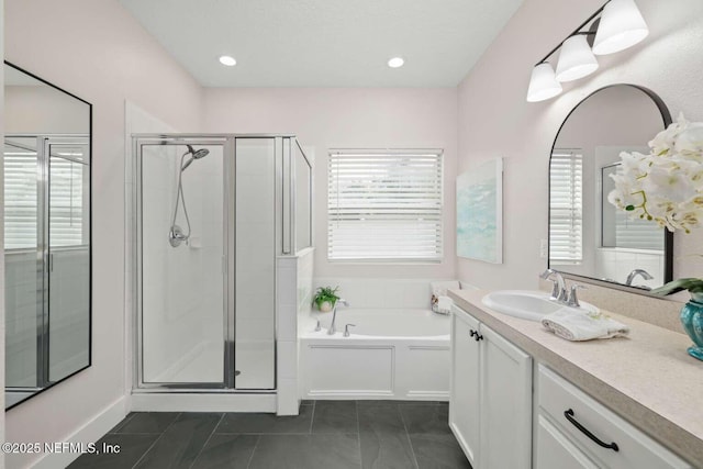 bathroom featuring a bath, a shower stall, and vanity