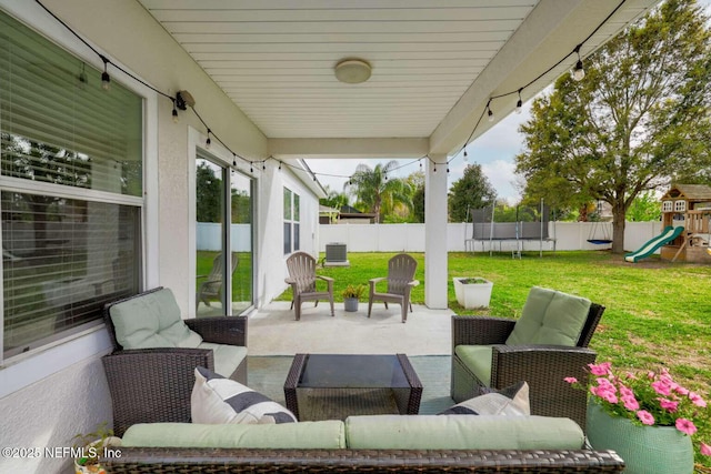 view of patio / terrace featuring a fenced backyard, a playground, a trampoline, and an outdoor hangout area