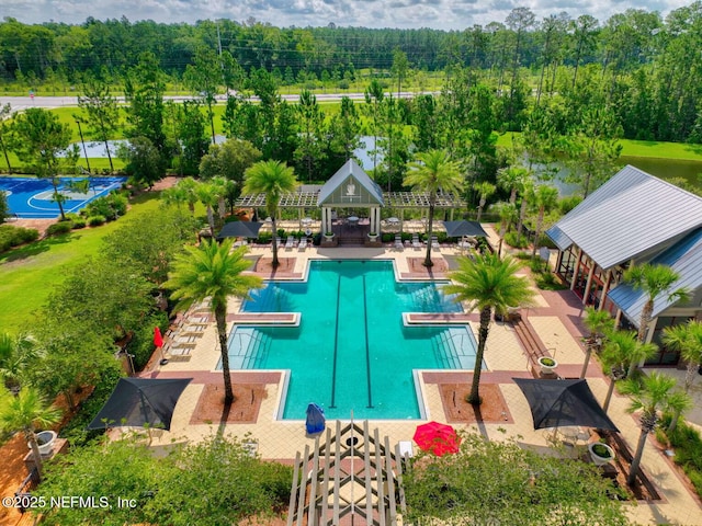 community pool with a patio area and fence