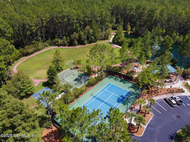 birds eye view of property featuring a view of trees