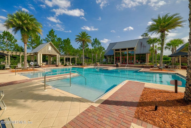 pool with a pergola and a patio area