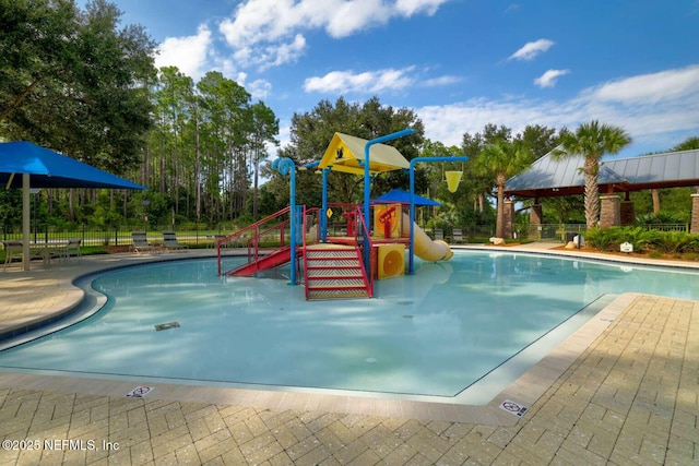 community playground with a community pool, a water play area, and fence