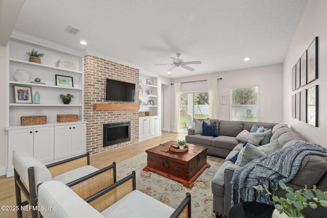 120 Corey Cay Ave, Saint Augustine, FL 32092 - living area with a textured ceiling, light wood finished floors, a ceiling fan, a fireplace, and recessed lighting