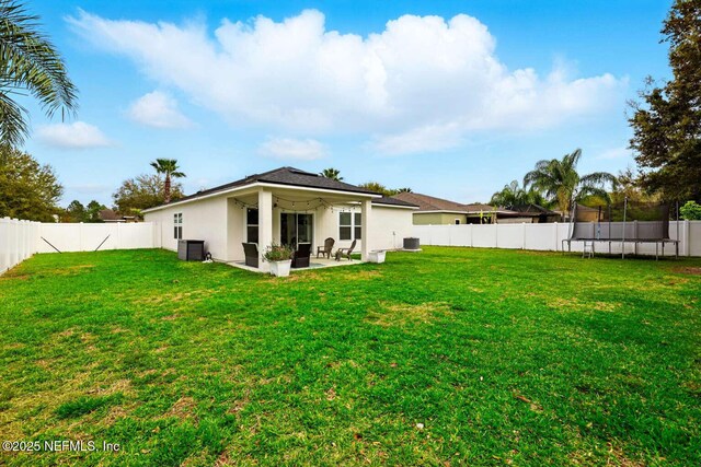 120 Corey Cay Ave, Saint Augustine, FL 32092 - rear view of property with a trampoline, stucco siding, a patio, and cooling unit
