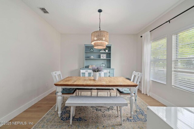 120 Corey Cay Ave, Saint Augustine, FL 32092 - dining room with baseboards, light wood-style flooring, and a chandelier