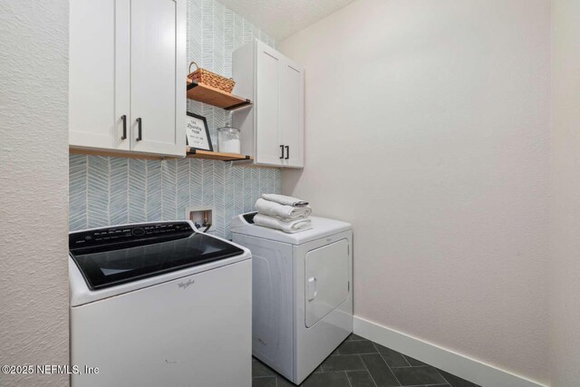 120 Corey Cay Ave, Saint Augustine, FL 32092 - laundry room with cabinet space, independent washer and dryer, dark tile patterned flooring, and baseboards