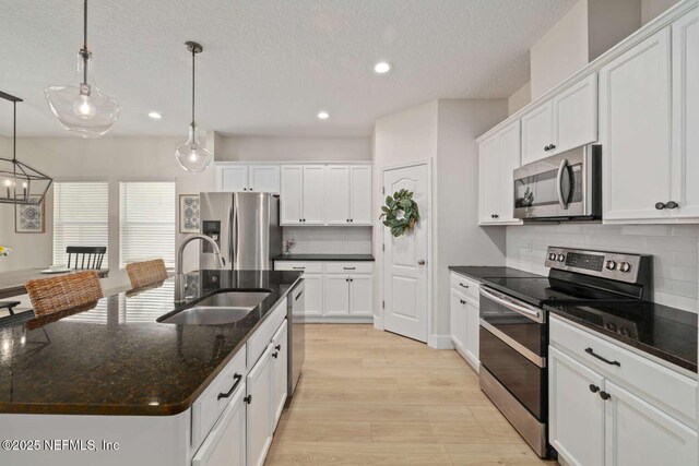 120 Corey Cay Ave, Saint Augustine, FL 32092 - kitchen featuring stainless steel appliances, a sink, recessed lighting, decorative backsplash, and light wood-style floors