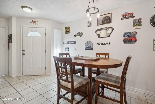 8634 Greatpine Ln W, Jacksonville, FL 32244 - dining space featuring baseboards, a textured ceiling, and light tile patterned flooring