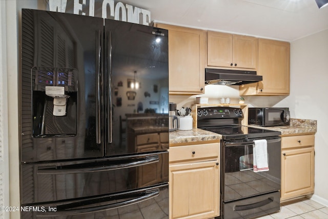 8634 Greatpine Ln W, Jacksonville, FL 32244 - kitchen with black appliances, light brown cabinetry, light tile patterned floors, light countertops, and under cabinet range hood