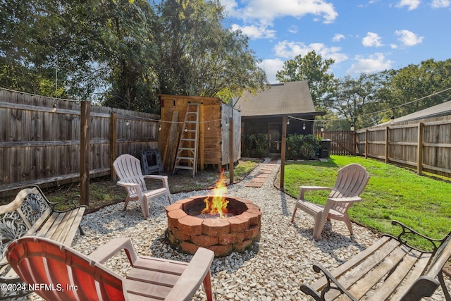 8634 Greatpine Ln W, Jacksonville, FL 32244 - view of patio / terrace with a fire pit, a fenced backyard, and an outdoor structure
