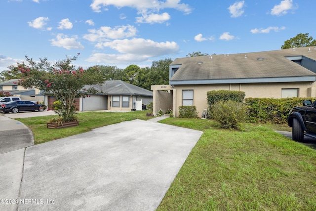 8634 Greatpine Ln W, Jacksonville, FL 32244 - view of property with a front lawn and stucco siding