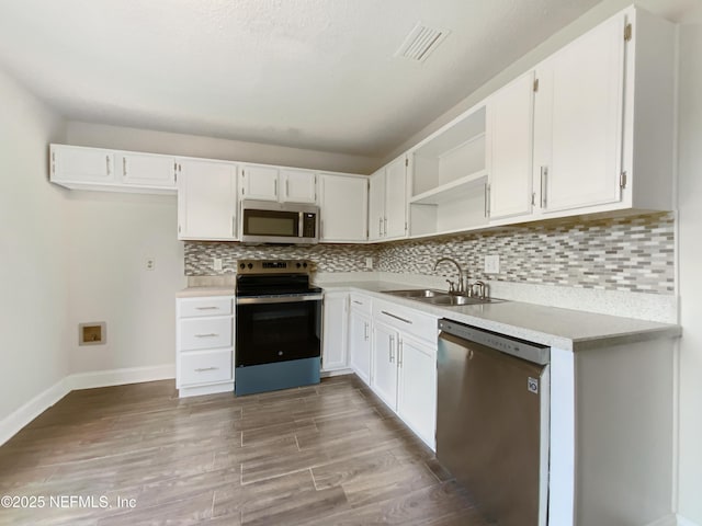 3444 Excalibur Way E, Jacksonville, FL 32223 - kitchen featuring white cabinets, stainless steel appliances, a sink, visible vents, and open shelves