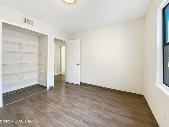 3444 Excalibur Way E, Jacksonville, FL 32223 - unfurnished bedroom featuring a closet, dark wood finished floors, visible vents, and baseboards