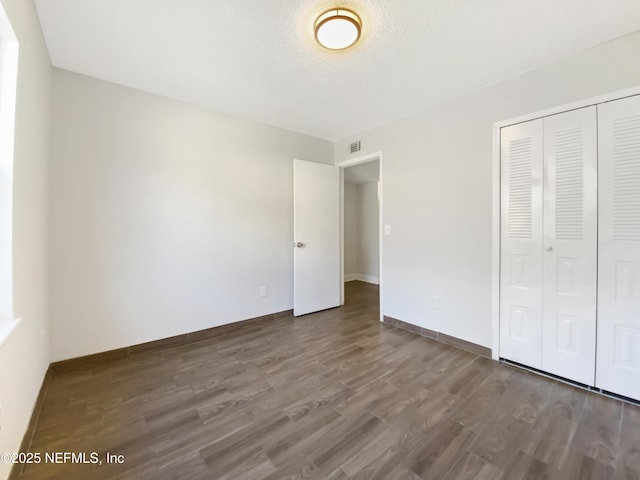 3444 Excalibur Way E, Jacksonville, FL 32223 - unfurnished bedroom featuring baseboards, wood finished floors, visible vents, and a closet