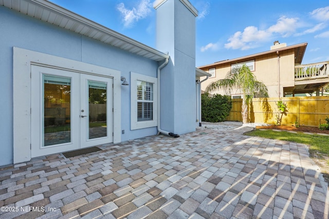 view of patio / terrace with french doors and fence