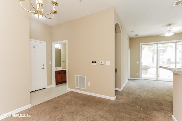 8601 Beach Blvd Unit 1202, Jacksonville, FL 32216 - unfurnished room with light colored carpet, a chandelier, a ceiling fan, and baseboards