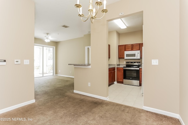 8601 Beach Blvd Unit 1202, Jacksonville, FL 32216 - kitchen with stainless steel electric range oven, white microwave, light carpet, a chandelier, and open floor plan