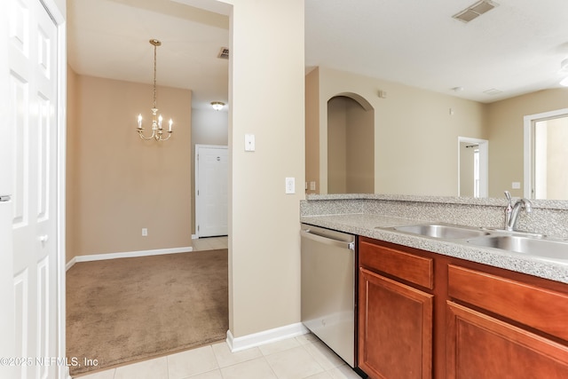 8601 Beach Blvd Unit 1202, Jacksonville, FL 32216 - kitchen with stainless steel dishwasher, a sink, light countertops, light colored carpet, and a chandelier