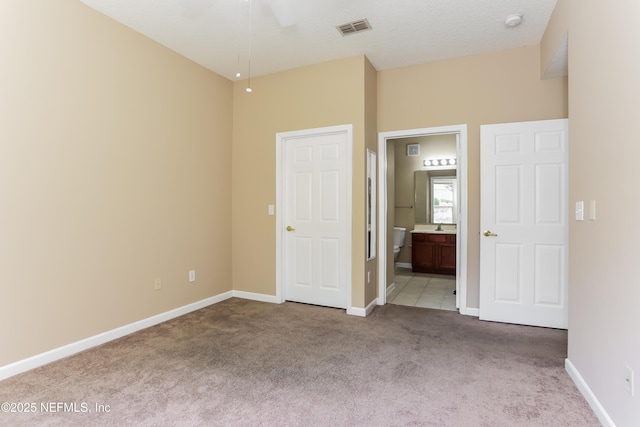 8601 Beach Blvd Unit 1202, Jacksonville, FL 32216 - unfurnished bedroom with carpet, connected bathroom, and baseboards