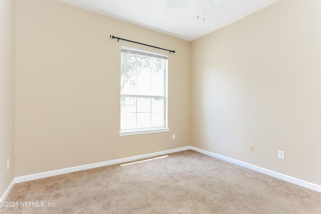 8601 Beach Blvd Unit 1202, Jacksonville, FL 32216 - unfurnished room with baseboards, carpet flooring, and a ceiling fan